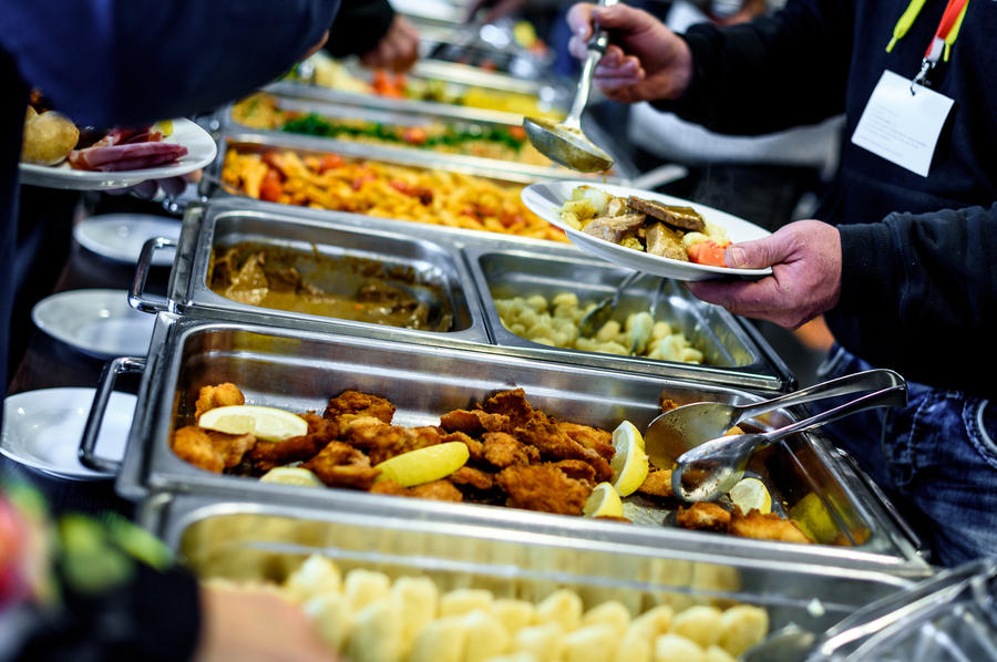 Cuisine Culinary Buffet Dinner Catering Dining Food Celebration Party Concept. Group of people in all you can eat catering buffet food indoor in luxury restaurant with meat and vegetables.