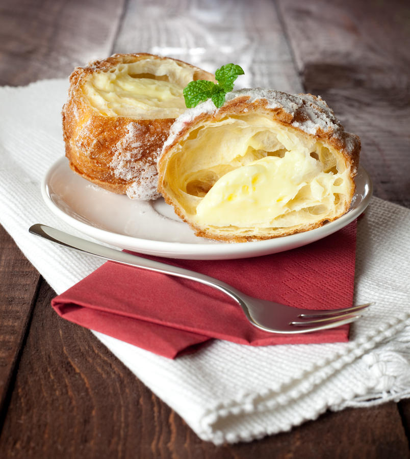 filled cream puff on a plate with fork