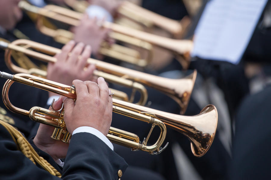 musicians are playing on trumpets