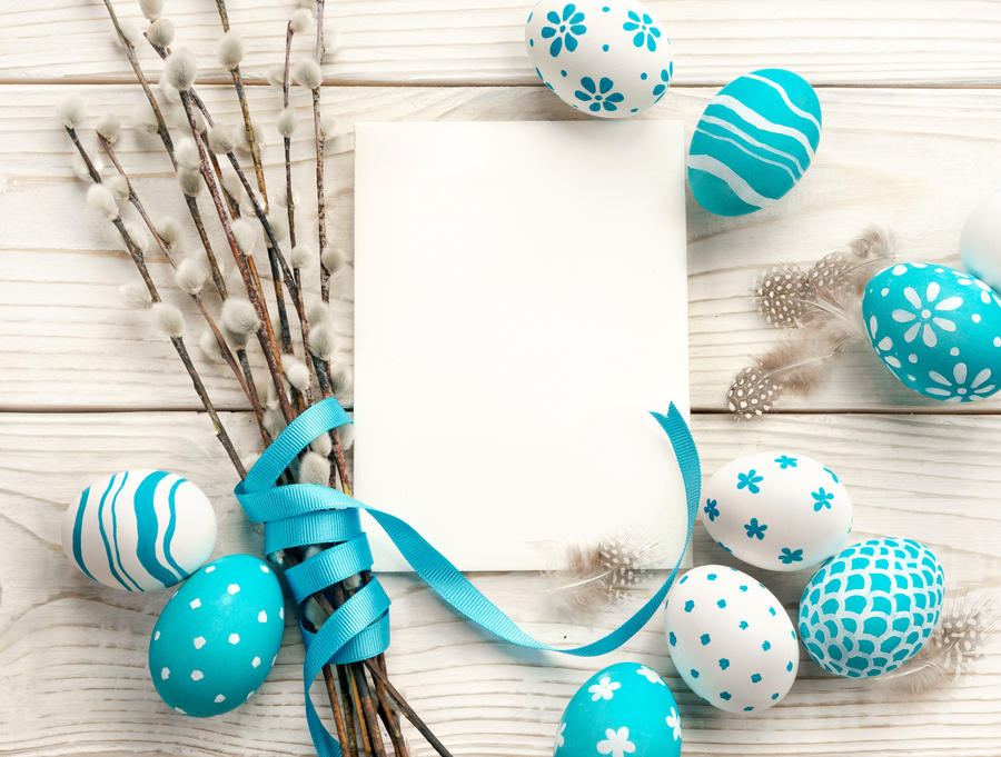 Easter background with Easter eggs and spring flowers. Top view with copy space.