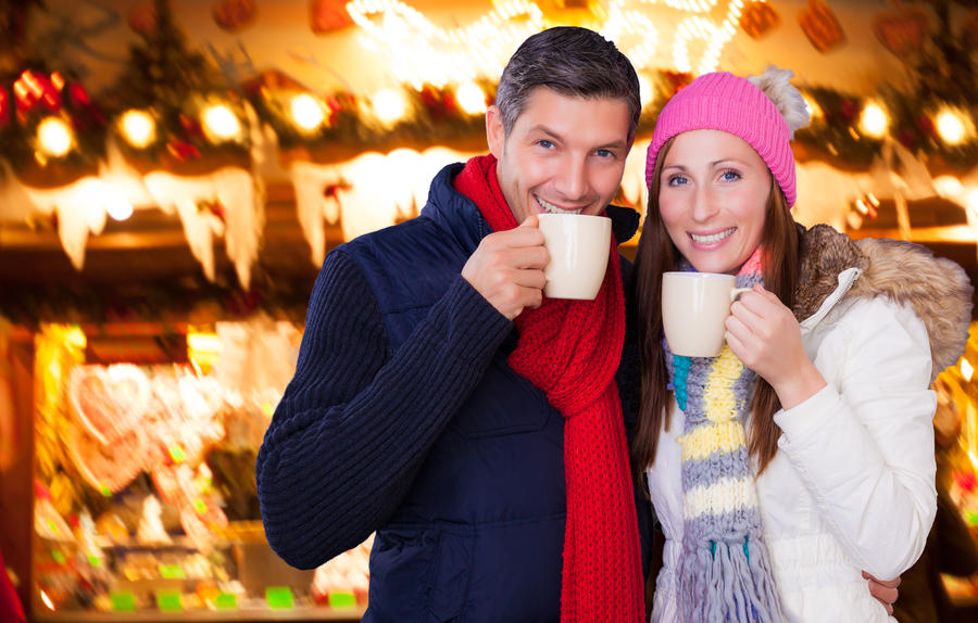 couple enjoying hot wine punch claret on christmas market