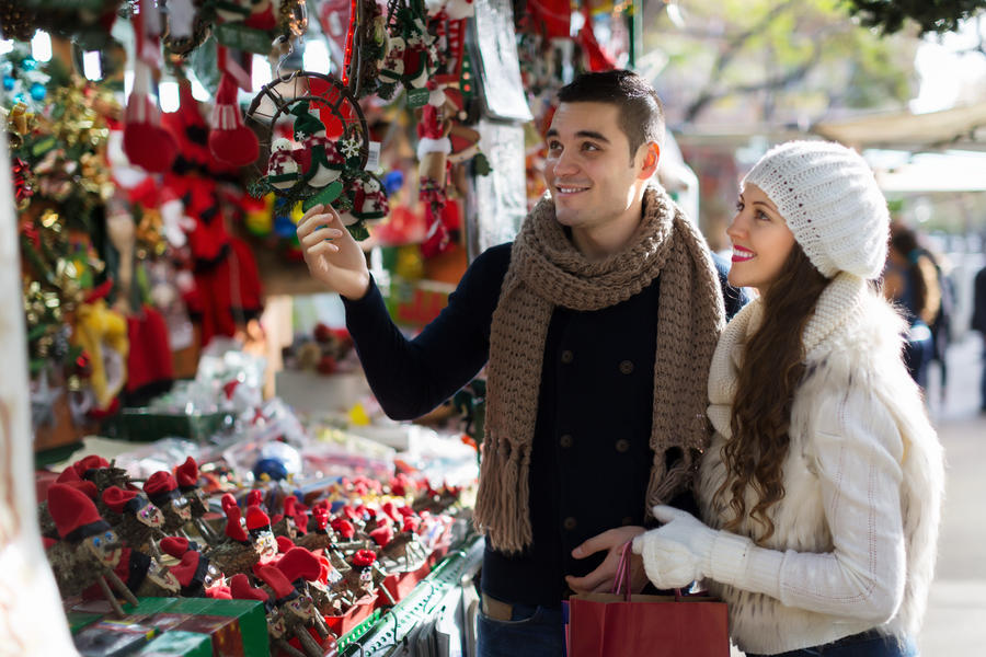 Happy  couple  choosing Christmas souvenirs at Barcelona