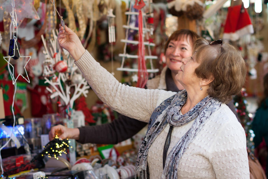 female pensioners buying X-mas decorations at Christmas market