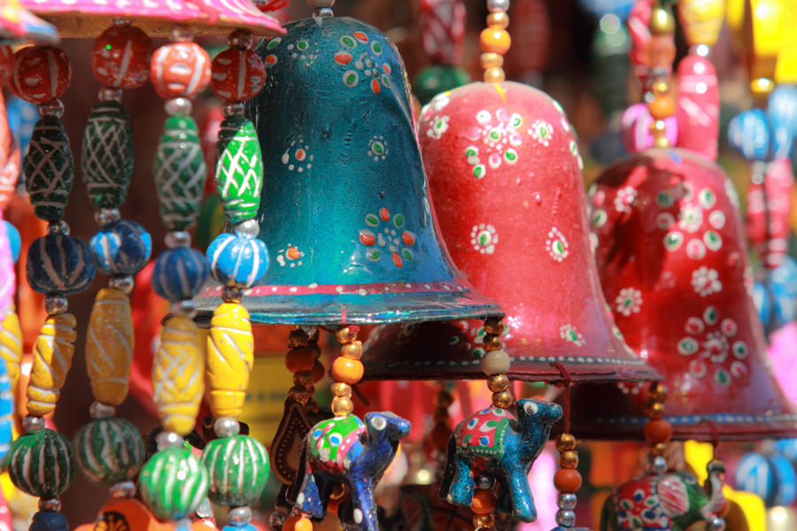 Colourful handmade wind chimes with decorated bells hanging in a local store in Rajasthan, India.