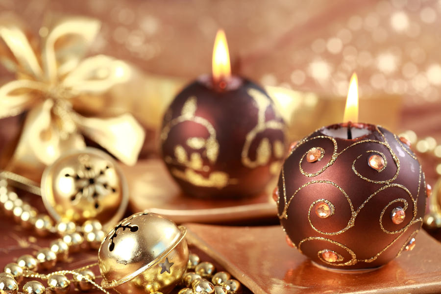 Christmas still life with candles and jingle bells in brown and golden tone