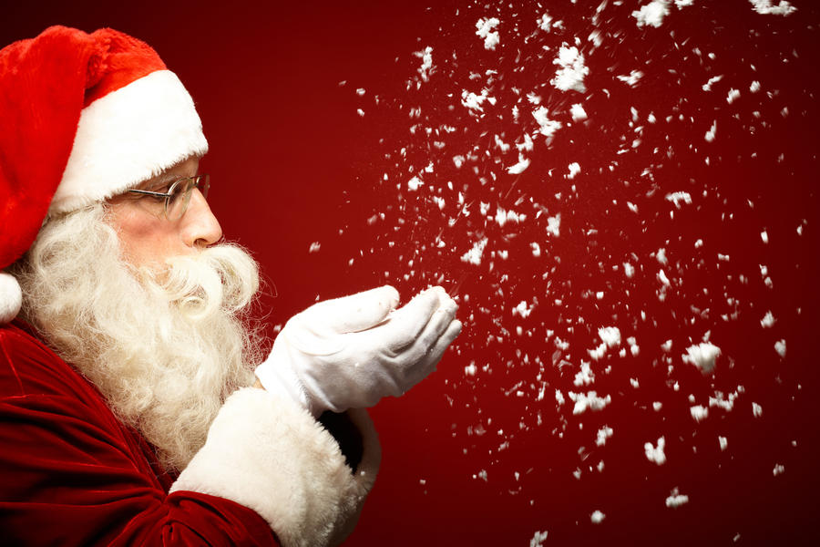 Photo of Santa Claus blowing snow and looking at it