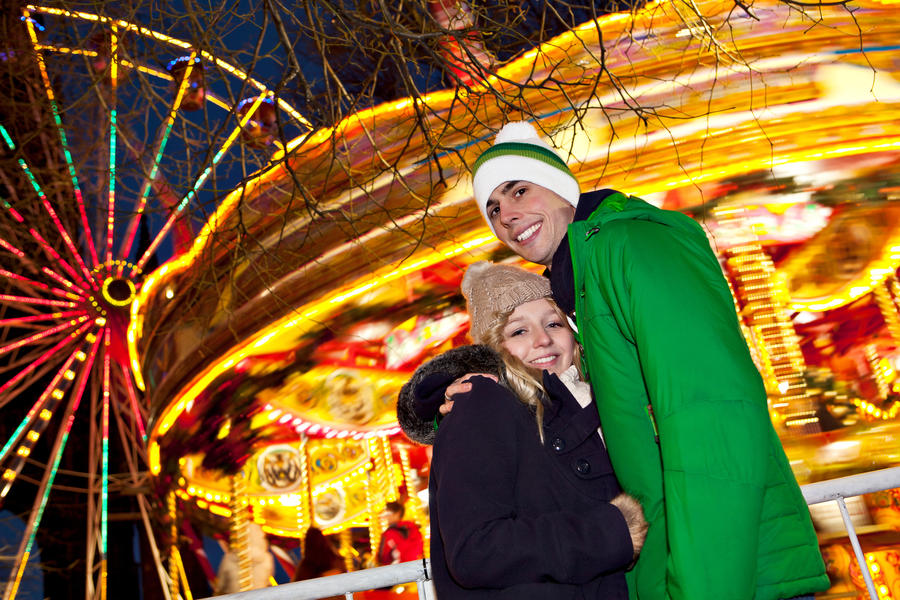 Young couple girl and man having good time on their date at German Christmas market