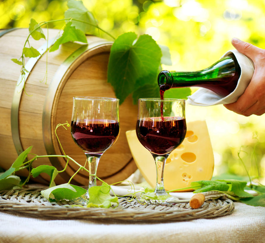 Wine. Red Wine and Cheese. Romantic Lunch Outdoor. Pouring Wine close-up. Outdoors