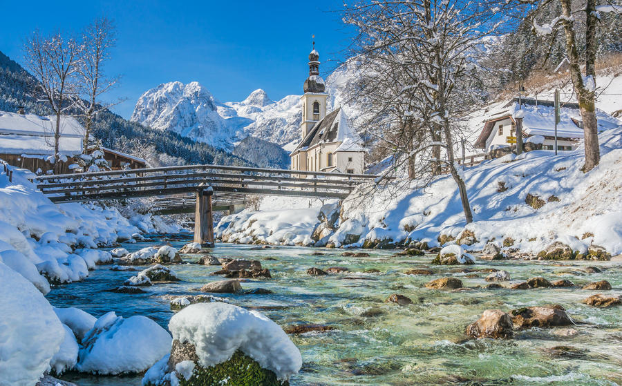 Panoramic view of scenic winter landscape in the Bavarian Alps with famous Parish Church of St. Sebastian in the village of Ramsau, Nationalpark Berchtesgadener Land, Upper Bavaria, Germany