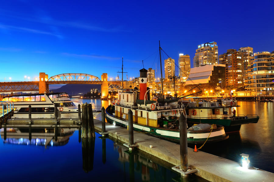 Vancouver False Creek at night with bridge and boat.