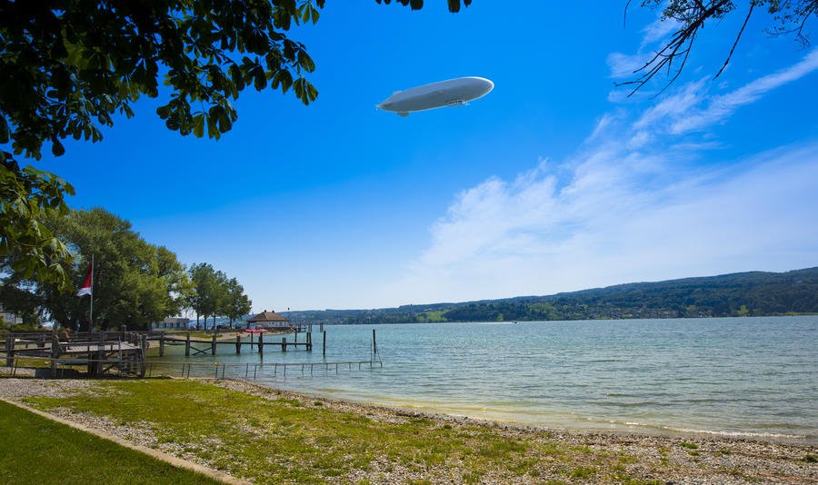 Wooden pier at Lake Constance on the Island of Reichenau with zeppelin, Lake Constance, Baden-Wuerttemberg, Germany, Europe