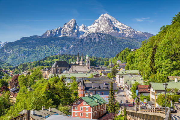 Historic town of Berchtesgaden with famous Watzmann mountain in the background on a sunny day with blue sky and clouds in springtime, Nationalpark Berchtesgadener Land, Upper Bavaria, Germany