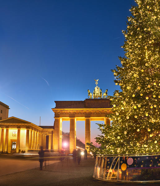 Brandenburger Gate in Berlin with Christmas tree at night with evening illumination, panoramic image