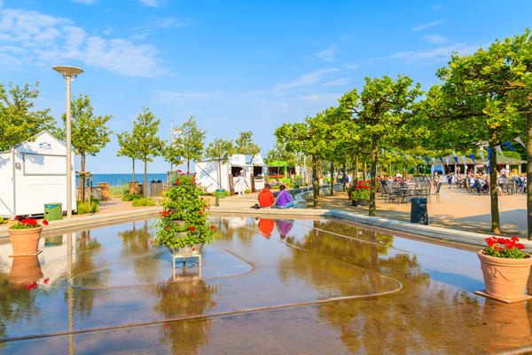 BAABE TOWN, RUEGEN ISLAND - MAY 31, 2018: Park with water fountain and flower pots in Goehren summer resort on Baltic Sea coast, Germany. Ruegen is popular tourist destination in northern Europe.