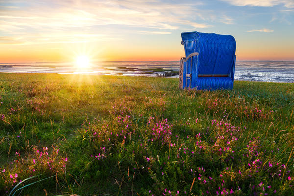 Beach baskets at the beach of Harlesiel, East Frisia while the sun goes down