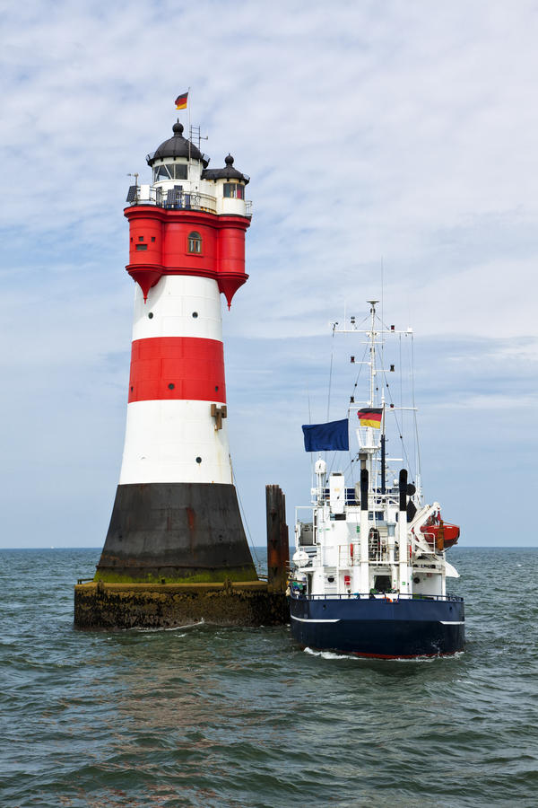 Supply ship moored at lighthouse Roter Sand in the german Wadden Sea