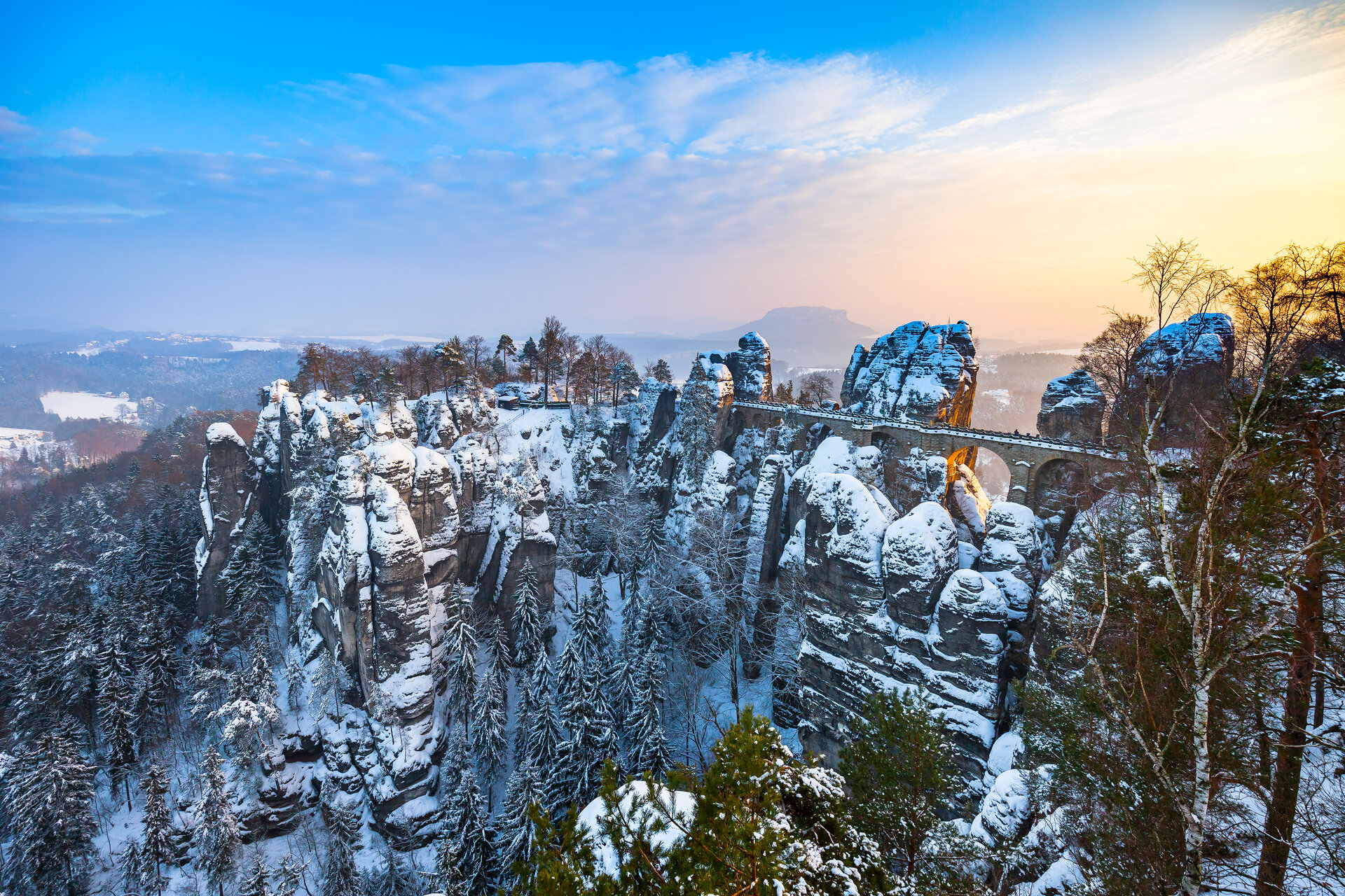 Famous Bastei in saxony covered with snow at sunrise