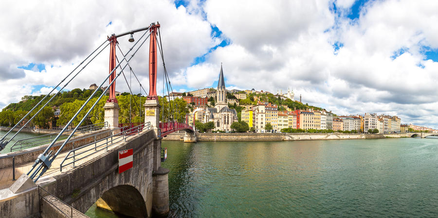 Pedestrian Saint Georges footbridge and the Saint Georges church in Lyon, France in a beautiful summer day