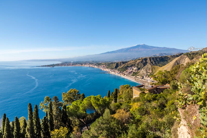 The bay of Giardini-Naxos with the Etna and Catania in the background viewed from Taormina, Sicily Italy. An HDR picture