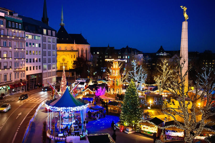 Christmas fair in Luxembourg. Aerial view of traditional Xmas market in old European city center. City decorated for winter holidays. Amusement and shopping for Christmas presents in Europe.