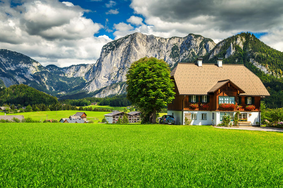 Amazing summer landscape with green fields, alpine farmland, pasture and high rocky mountains in background, Altaussee, Salzkammergut, Austria, Europe