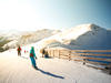 Snowboarders and skiers on the slope. Sunny winter day in the mountain ski resort, Saalbach Hinterglemm Leogang, Austria, Alps, Europe.