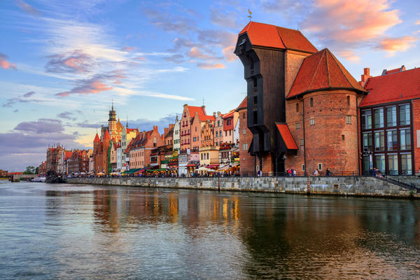The Zuraw Crane and colorful gothic facades of the old town in Gdansk, Poland, on sunset