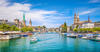 Panoramic view of historic Zurich city center with famous Fraumunster and Grossmunster Churches and river Limmat at Lake Zurich on a sunny day with clouds in summer, Canton of Zurich, Switzerland