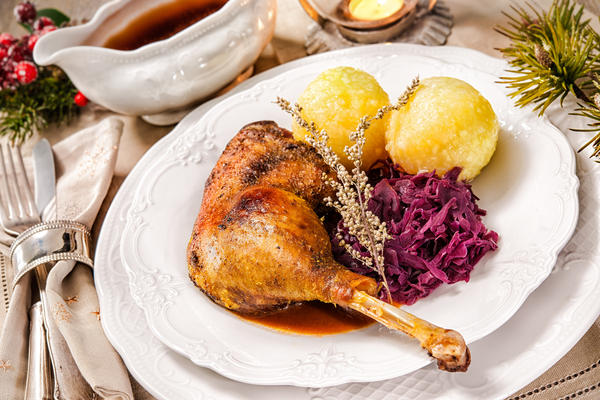 Crusty Christmas goose leg with braised red cabbage and dumplings