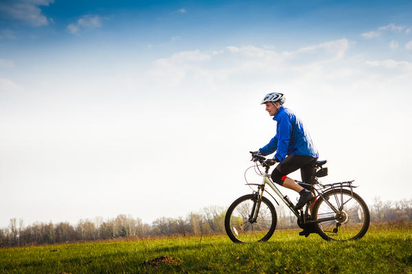 Cyclist on the Beautiful Meadow Trail on sunny day