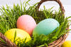 Closeup view of colorful pastel eggs. Easter decoration concept. Basket with painted eggs for Easter hunt. Selective focus
