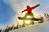 Snowboarder jumping through air with deep blue sky in background