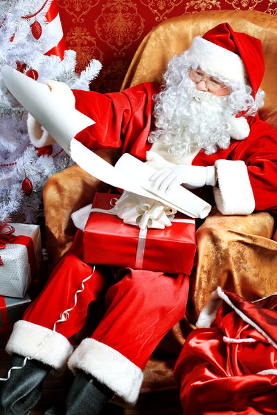 Santa Claus with presents and New Year tree at home. Christmas.